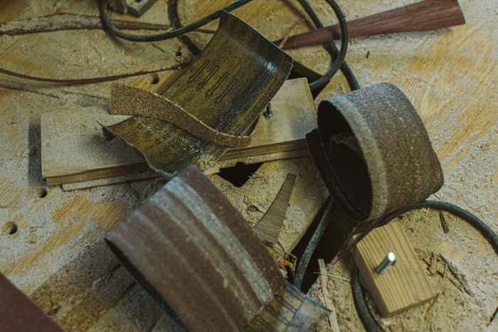 sawdust and sandpaper on wooden surface